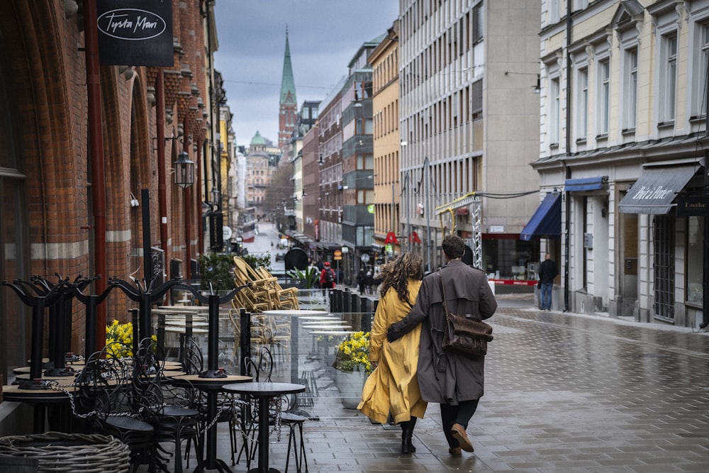 a couple of people walking down a street