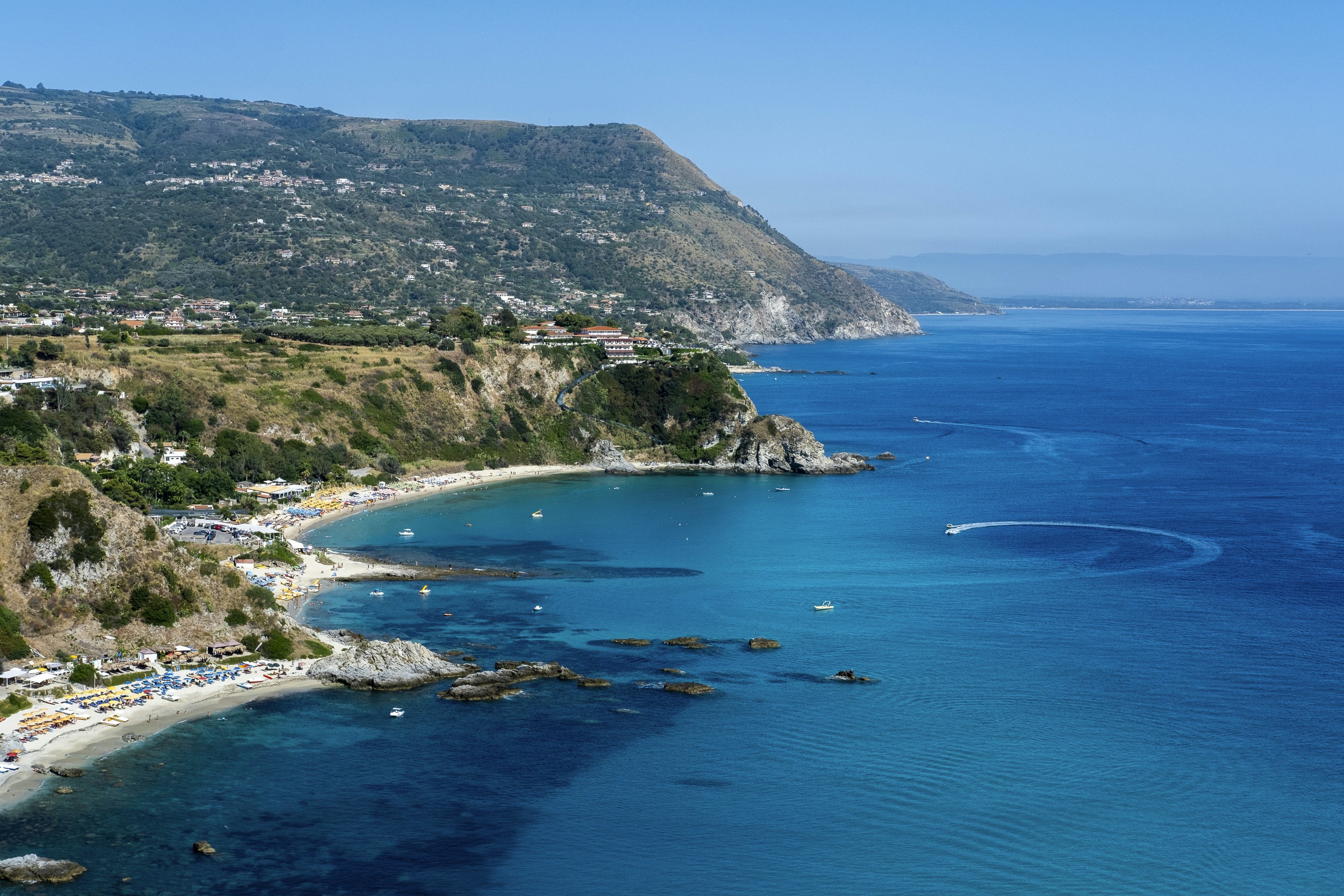 a view of a beach with a boat in the water, 
