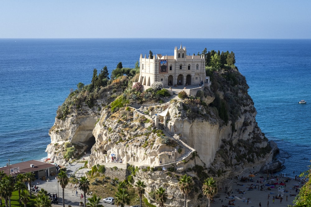 a castle perched on top of a cliff next to the ocean