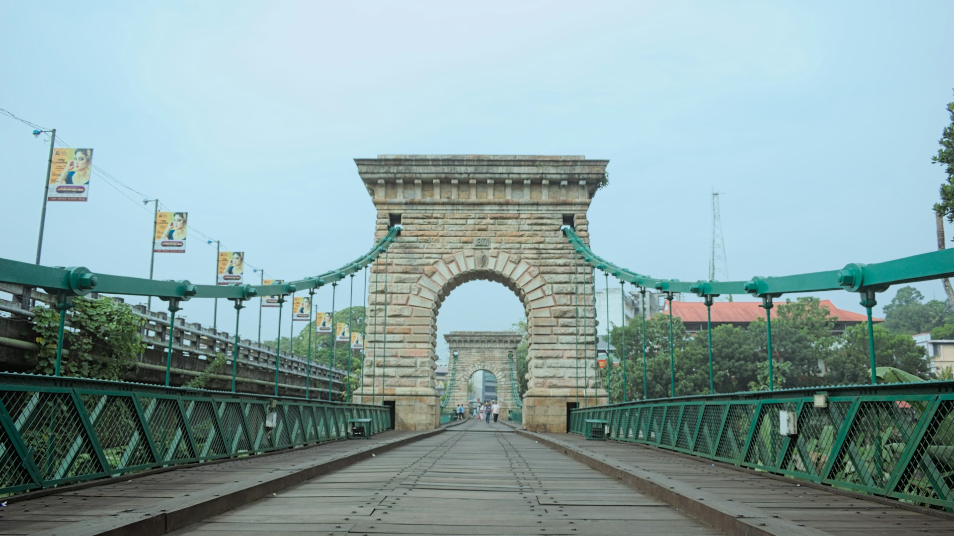 a bridge that has a green metal fence on it