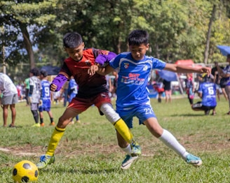 a group of young men kicking around a soccer ball