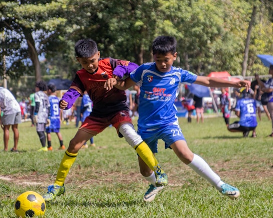 a group of young men kicking around a soccer ball