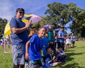 A community event showcasing youth sports activities, with families and supporters cheering on the participants.