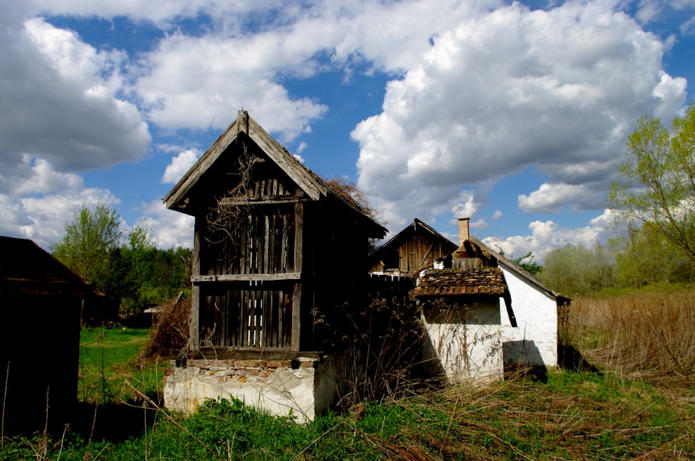 an old run down building in the middle of a field