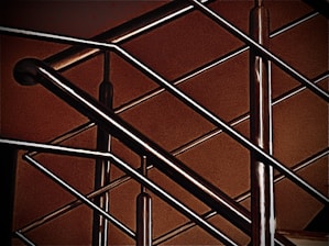 Close-up of a custom metal railing being TIG welded on-site at a residential property.