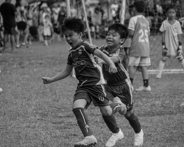 Kids chasing the ball in a youth soccer match