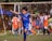 a young boy kicking a soccer ball around a field