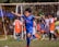 a young boy kicking a soccer ball around a field