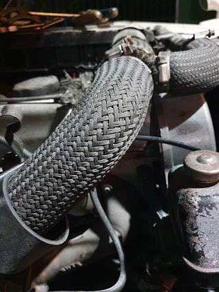 Close-up of a sleek automotive wiring harness wrapped neatly with takino adhesive tape, highlighting texture and precision.