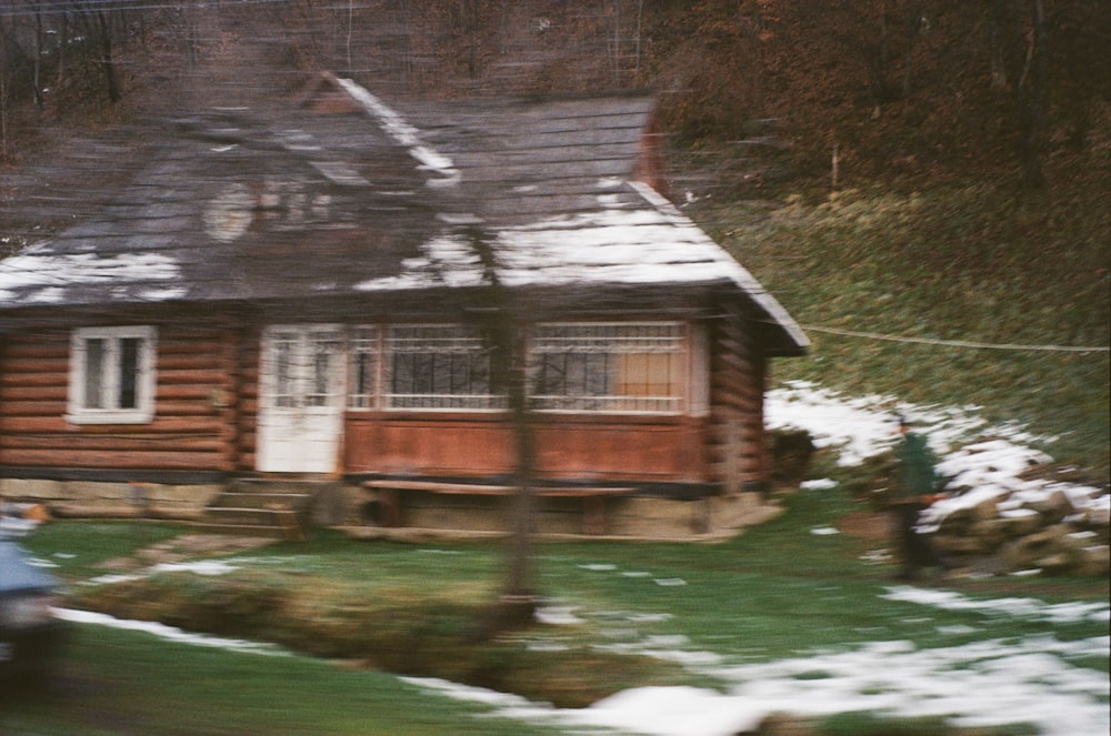 a car is parked in front of a log cabin