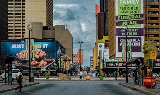 Wide shot of a street lined with businesses, each featuring eye-catching LED totem banners