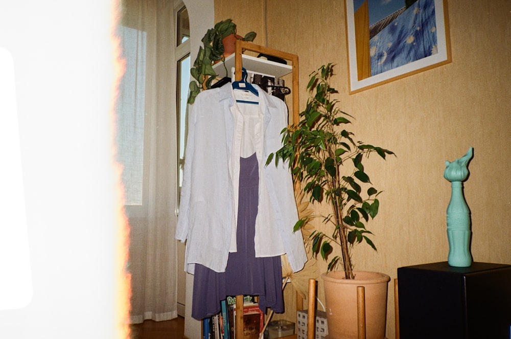 a white shirt hanging on a rack in a room