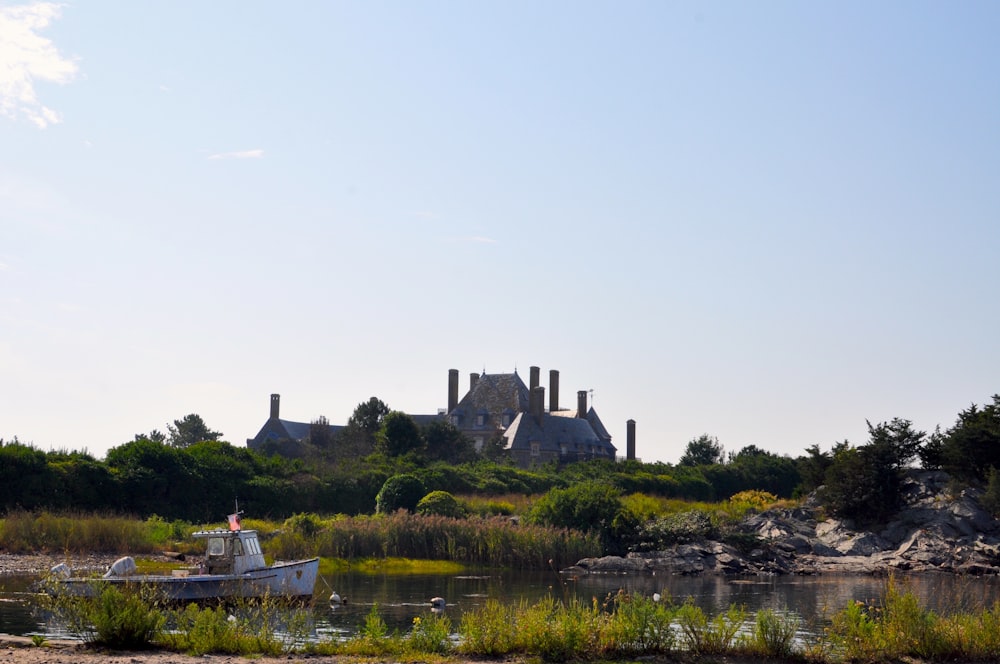 a boat in a body of water in front of a castle