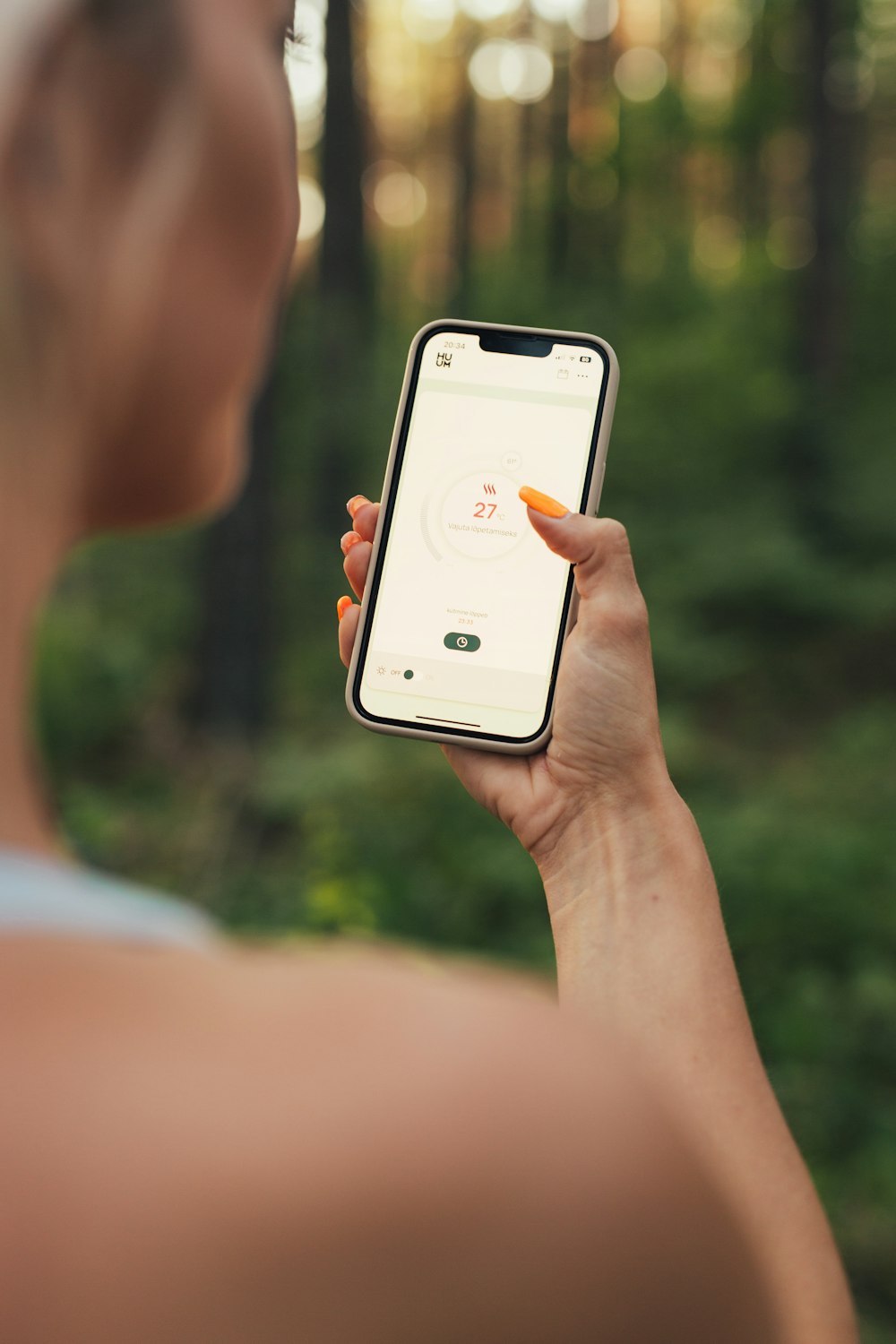 a woman holding a cell phone in her hand