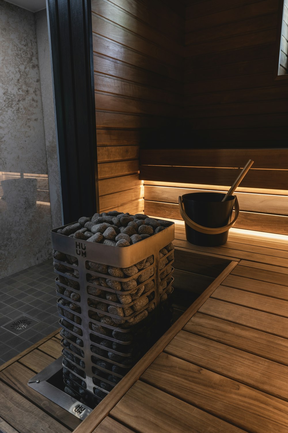 a bucket of rocks sitting on top of a wooden floor