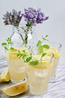 a pitcher of lemonade and two glasses of lemonade