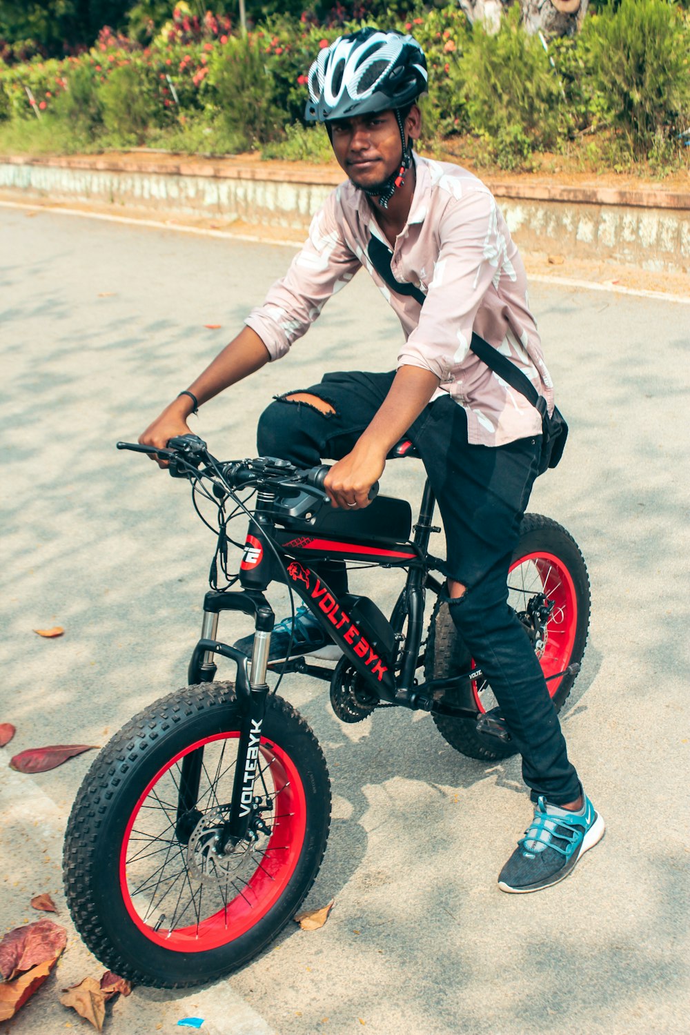 a man in a helmet is riding a small bike