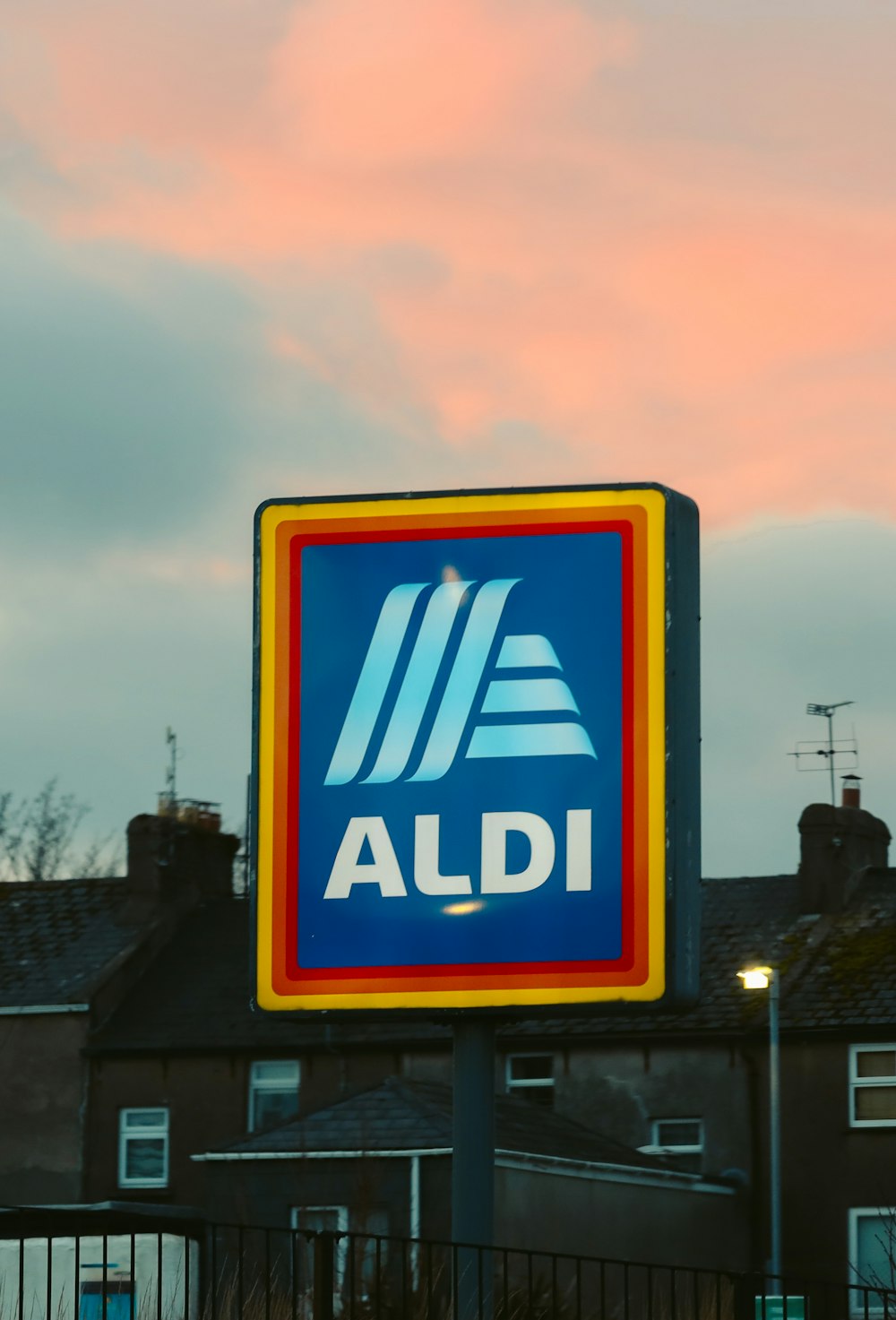 a blue and yellow aldi sign in front of a building