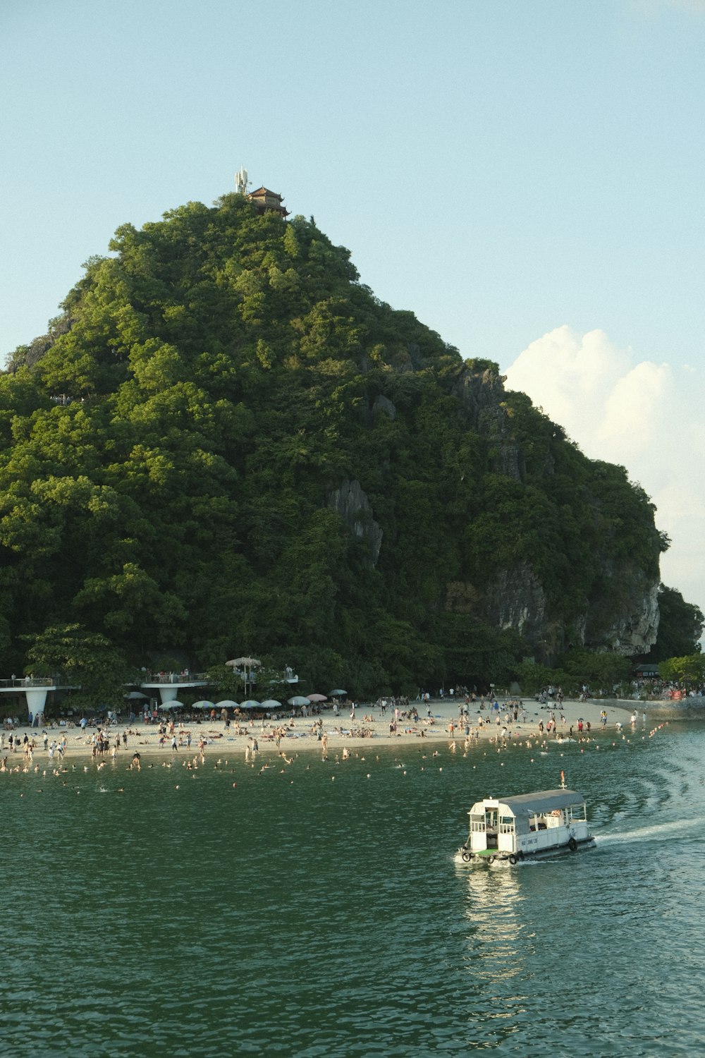 a boat is in the water near a large island