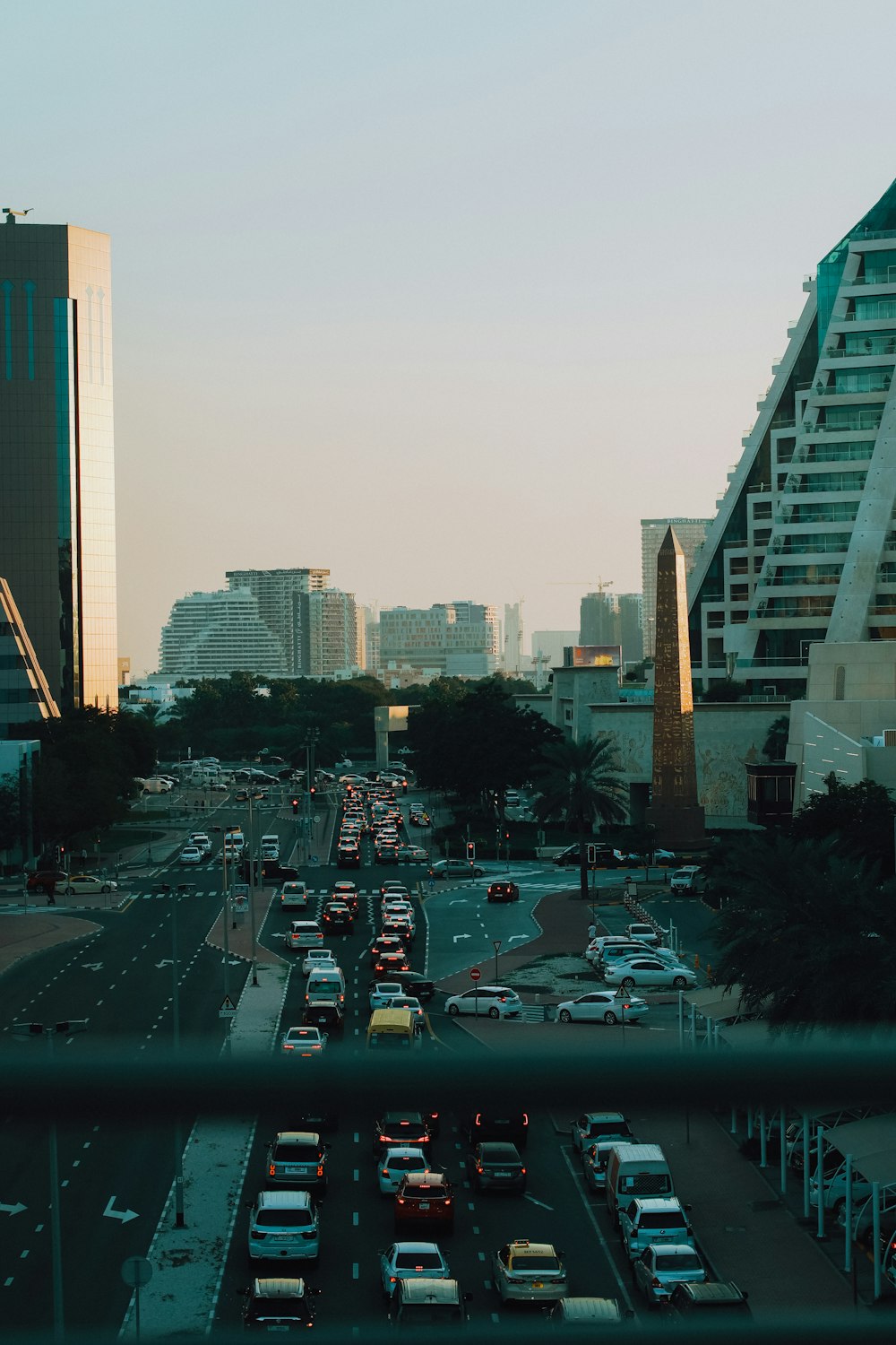 a city street filled with lots of traffic next to tall buildings