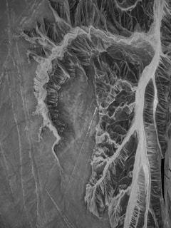 a black and white photo of an aerial view of a river