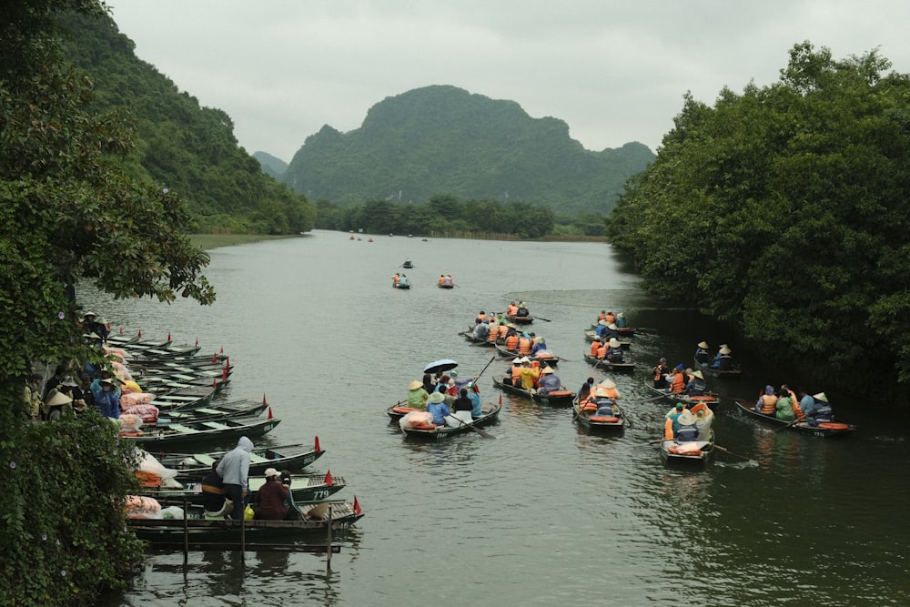 a group of people in small boats on a river