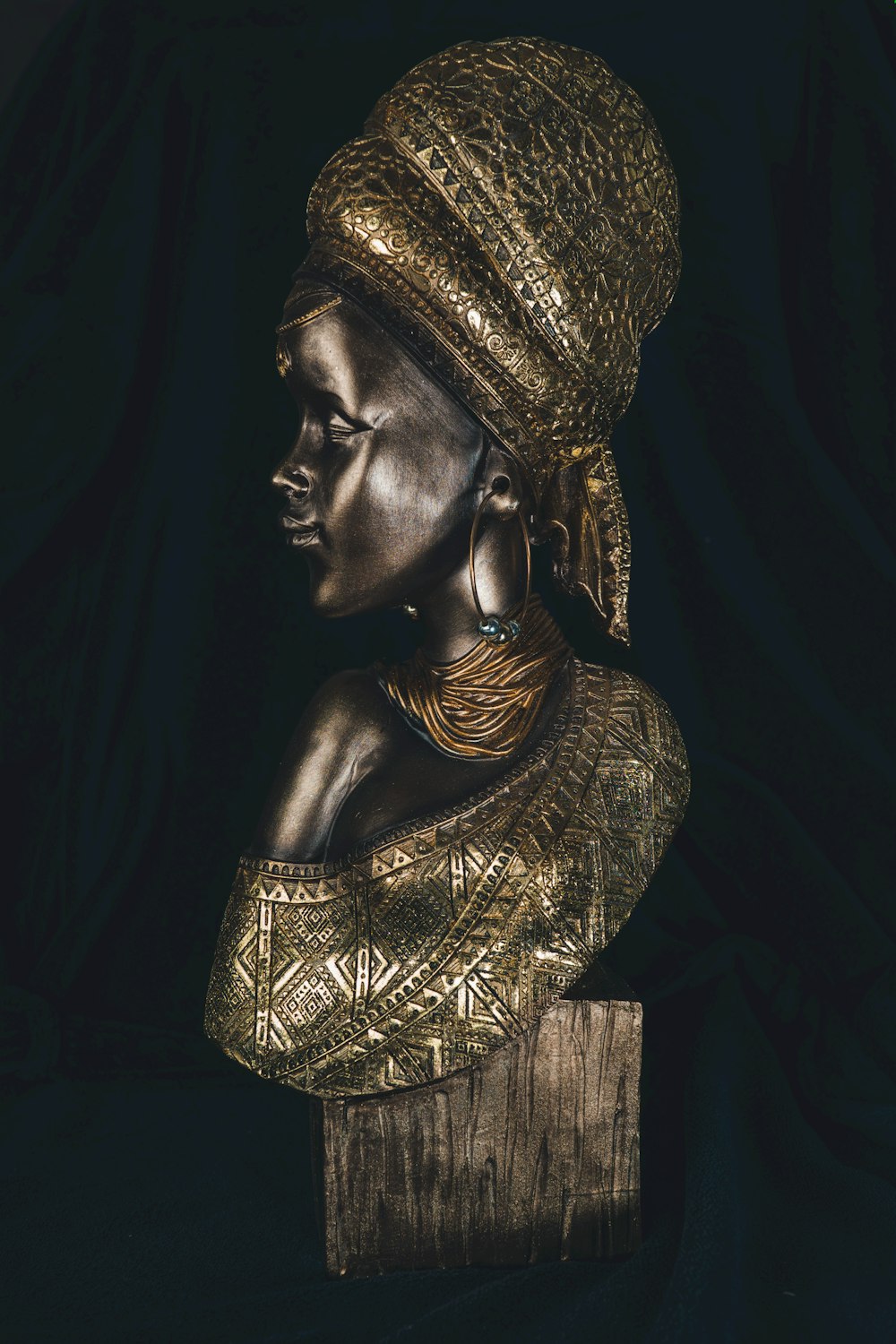 a statue of a woman wearing a gold headdress