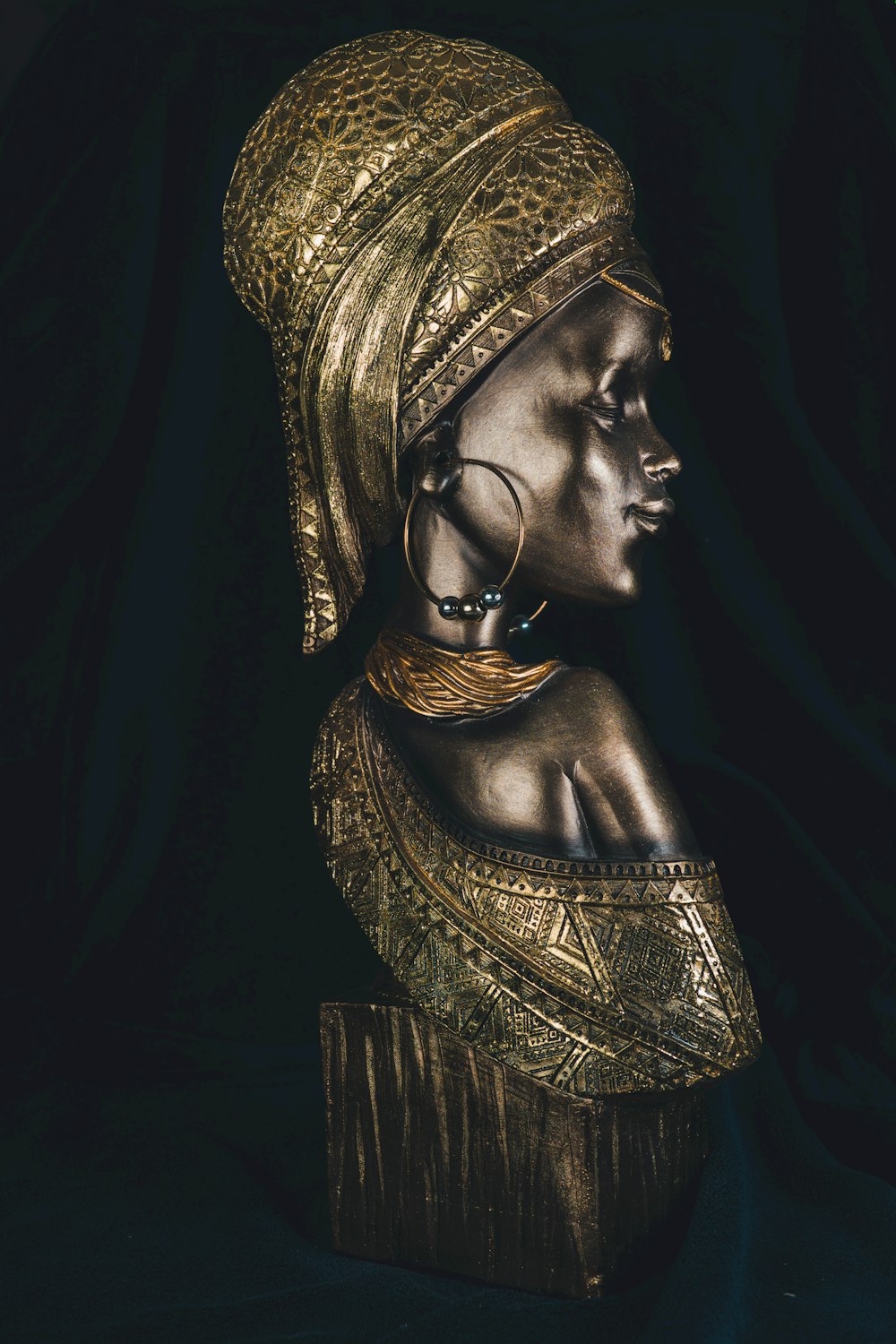 a statue of a woman wearing a gold headdress