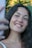 a woman is smiling and holding a cell phone
