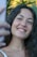 a woman is smiling and holding a cell phone