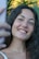 a woman is smiling and holding a cell phone