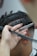 Close-up of a hairstylist carefully cutting a client's hair in a modern salon.