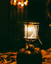 A dimly lit vintage lantern casting shadows on an old wooden table.