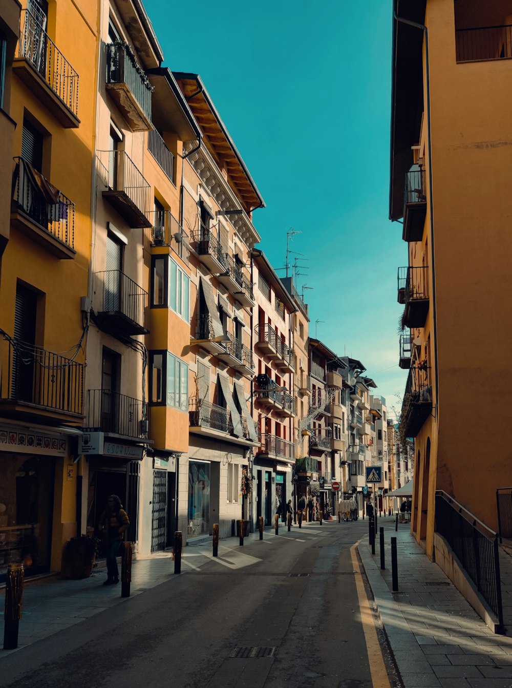 a city street lined with tall buildings and balconies