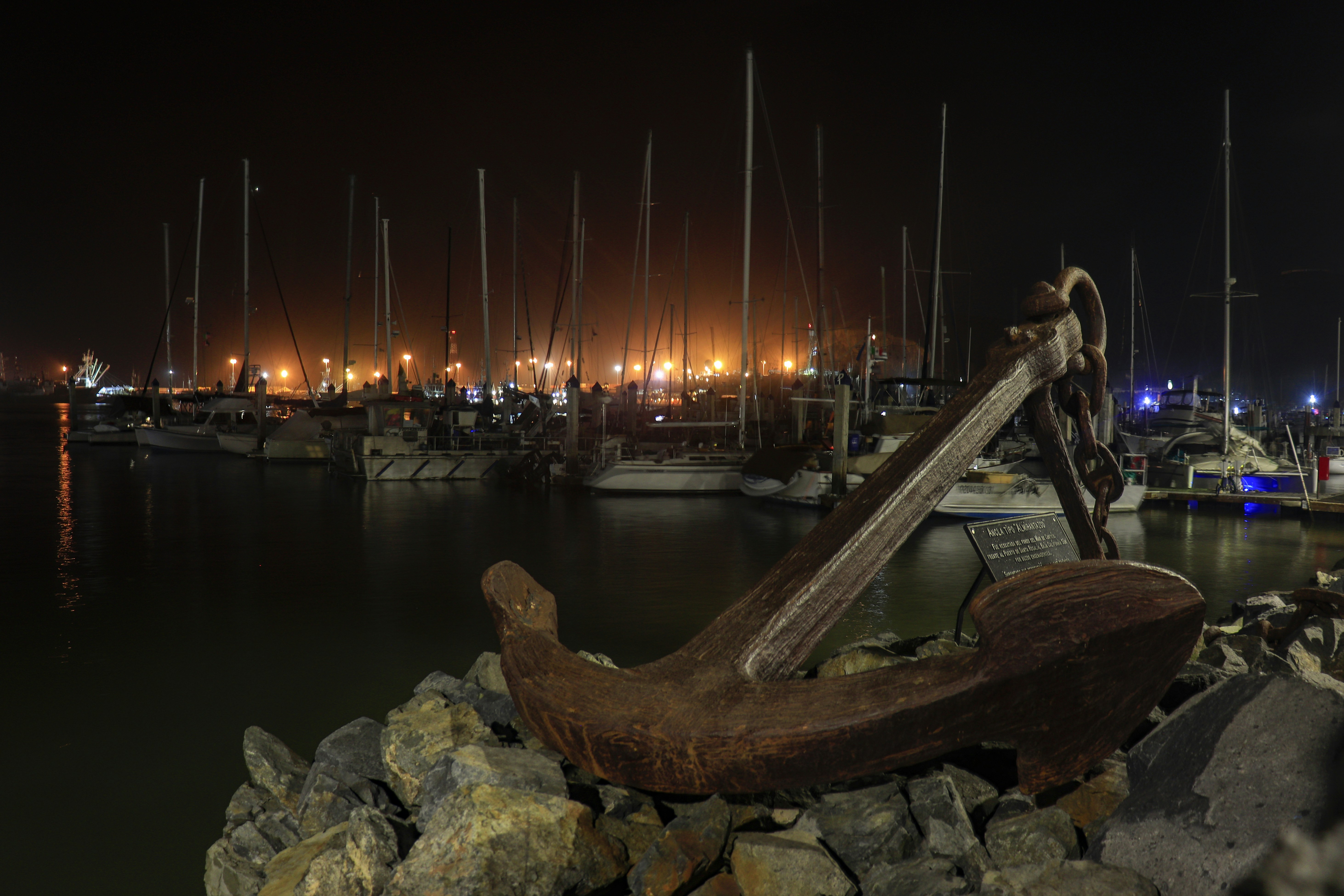 A statue of a man playing a guitar in a harbor photo Free Ensenada
