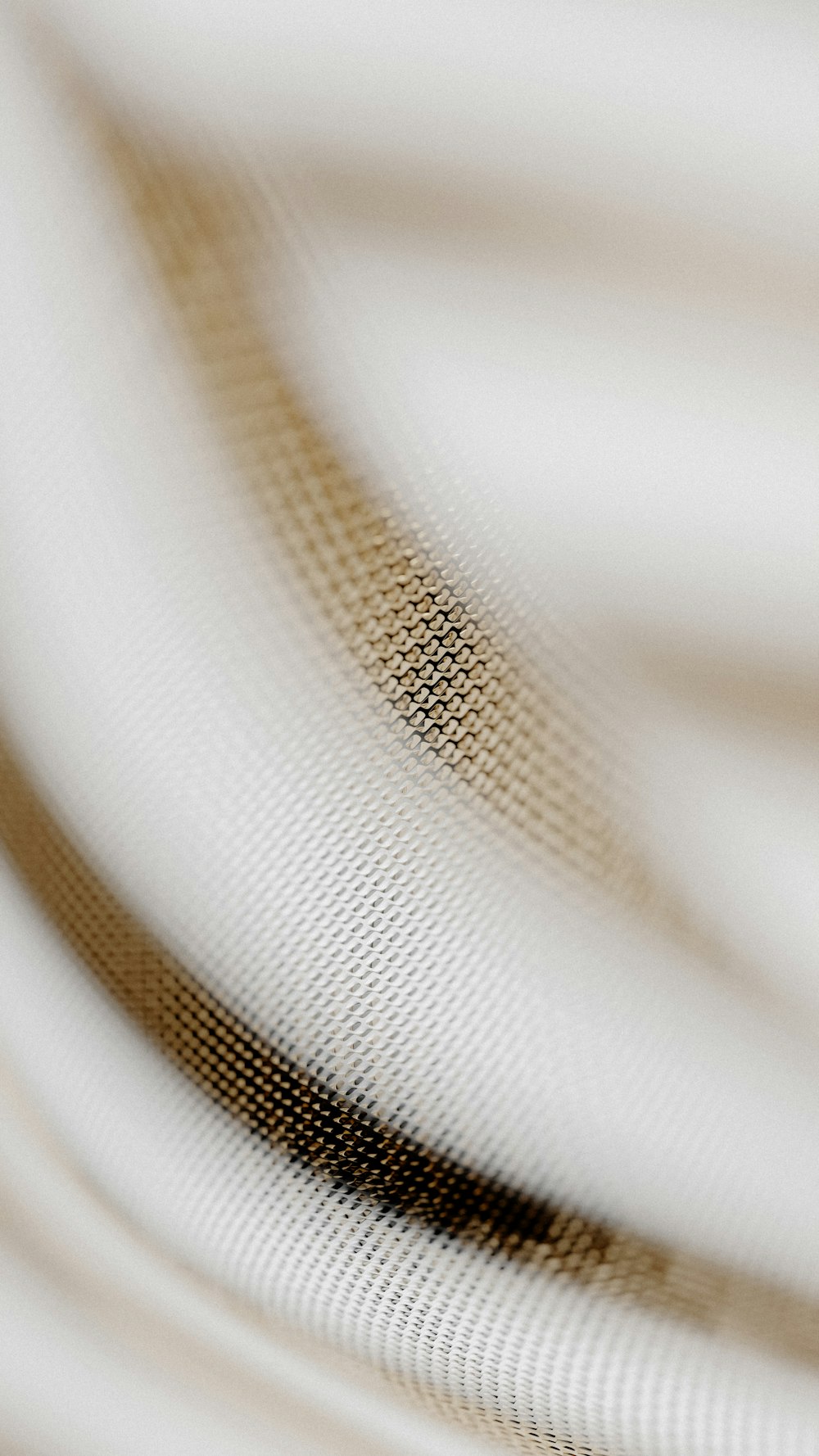 a close up of a white fabric with a brown stripe