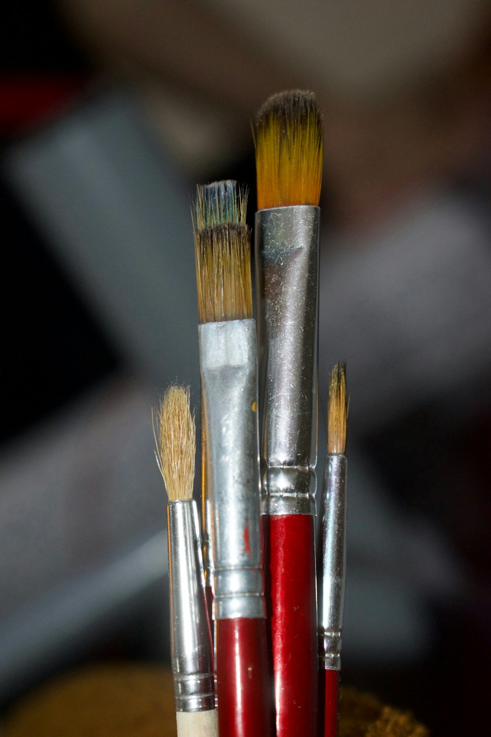 a group of brushes sitting on top of a wooden table