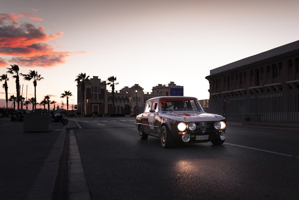 a truck driving down a street next to palm trees