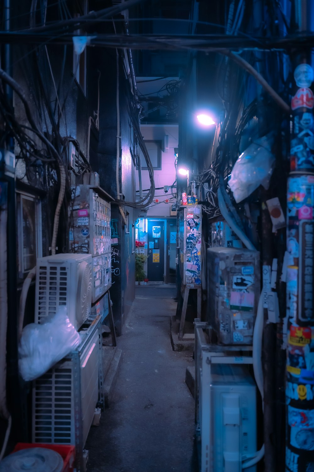 a narrow alley way with lots of electrical equipment