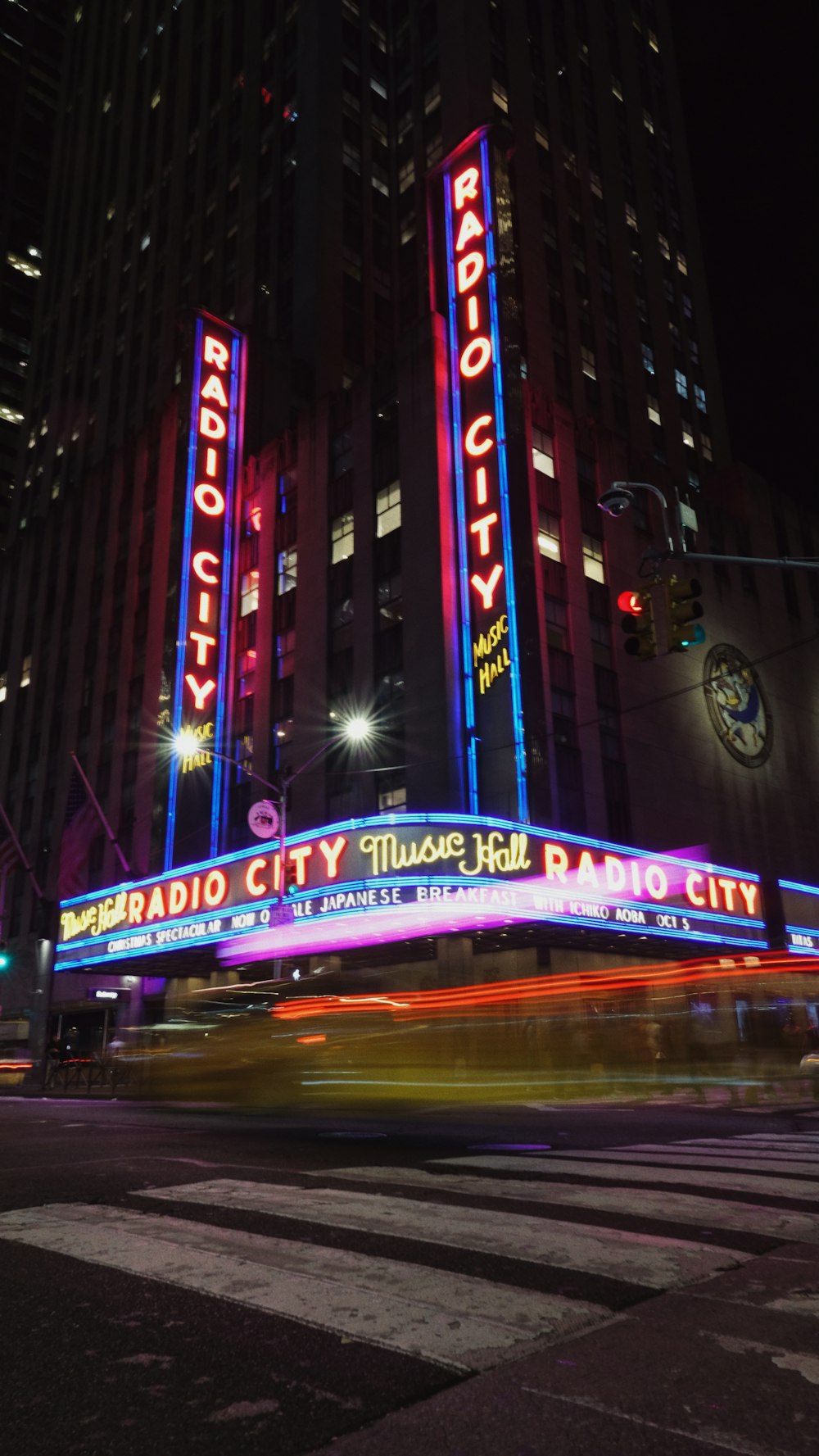 the radio city music hall is lit up at night