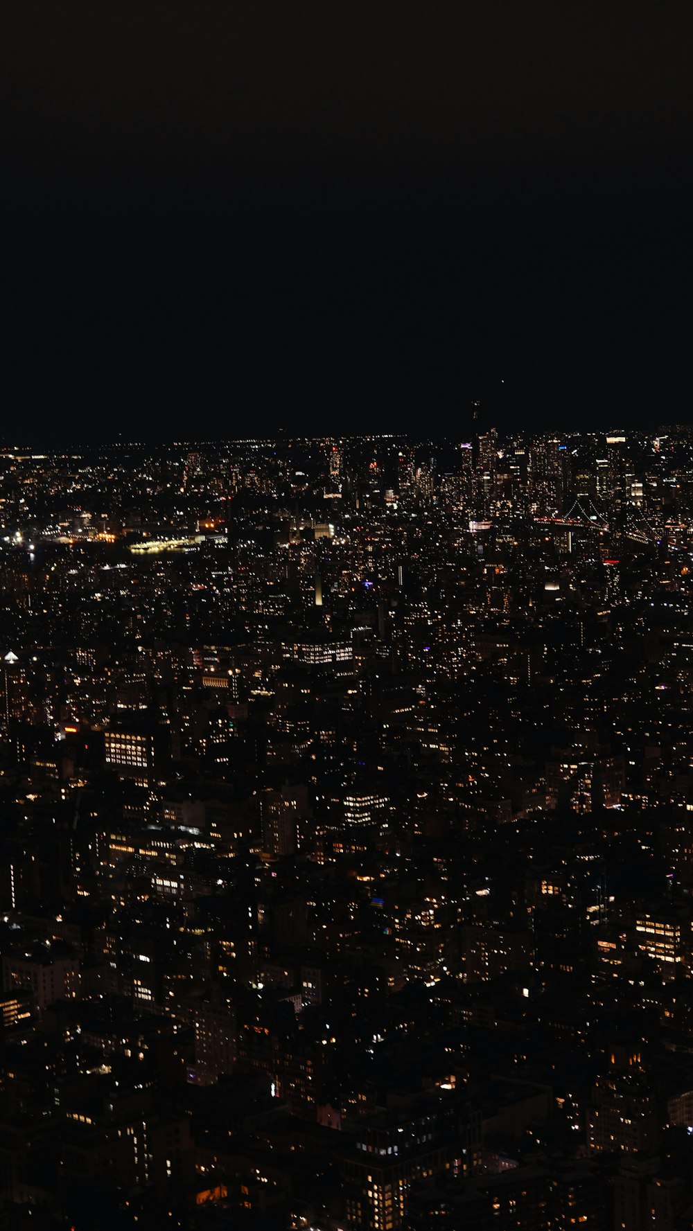 a view of a city at night from the top of a building