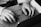 A close-up of hands typing on a keyboard with a notepad beside it.