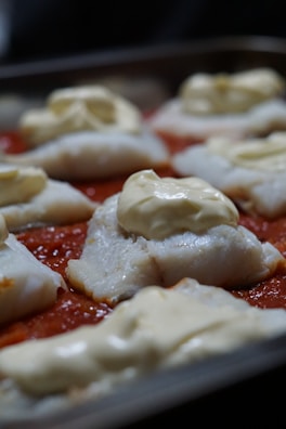 Slices of rich fish pie showing creamy filling and tender fish chunks.