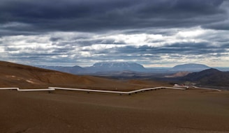 Pipeline infrastructure stretching across a desert landscape.