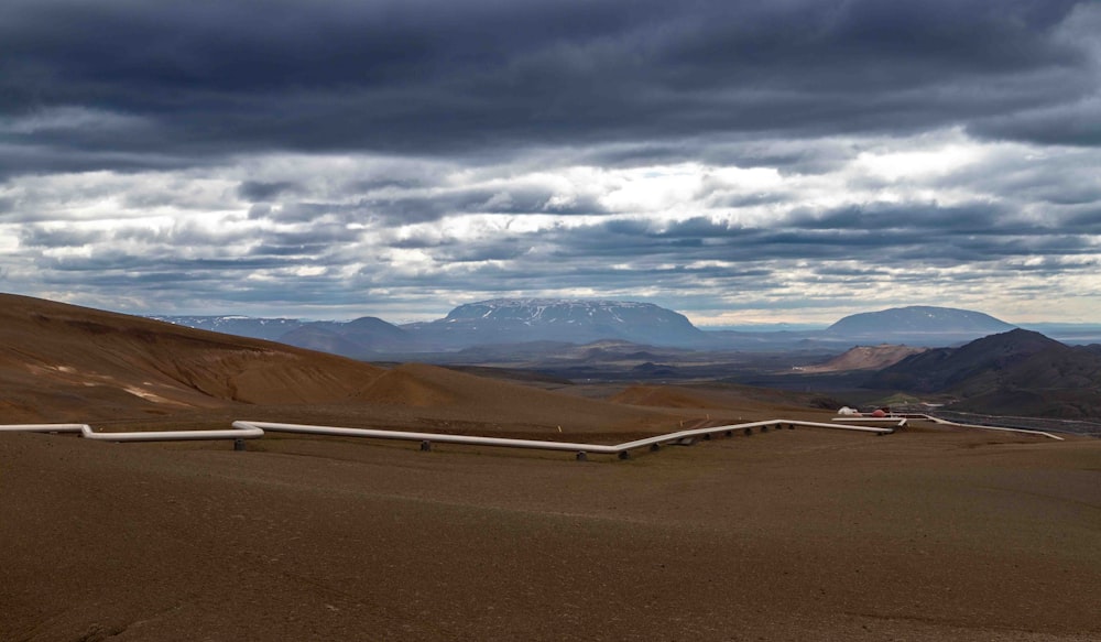 Un campo sterrato con montagne sullo sfondo