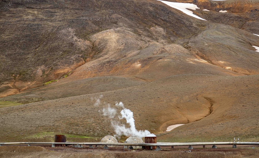 a steam train traveling through a mountain range