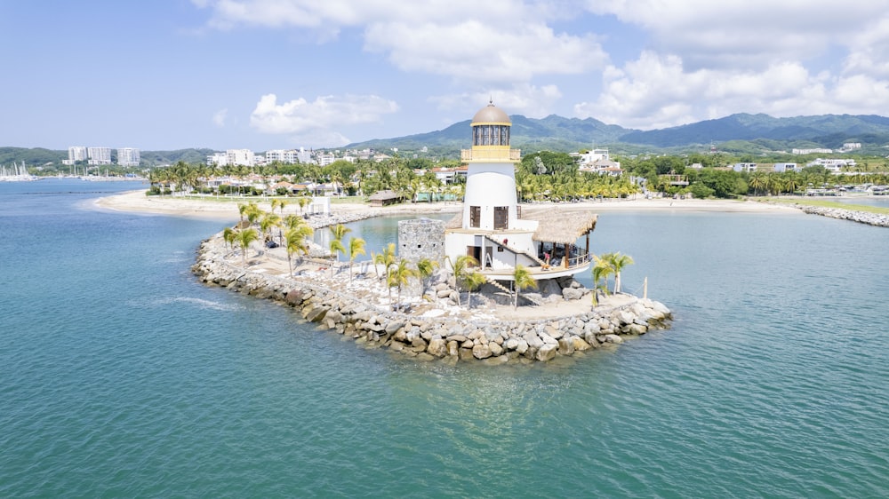 an island with a lighthouse on it in the middle of the ocean