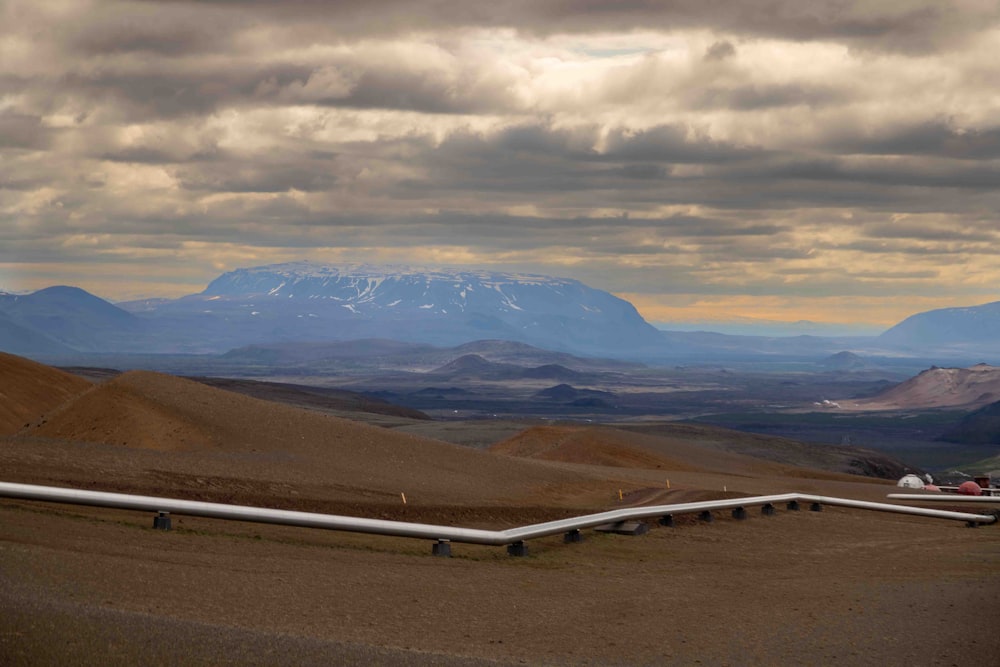 a view of a mountain range with a pipe in the foreground