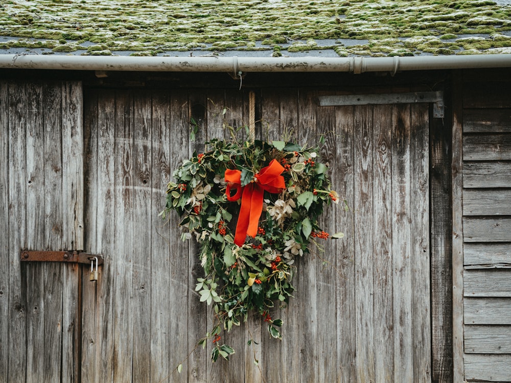 a wreath hanging on the side of a wooden building