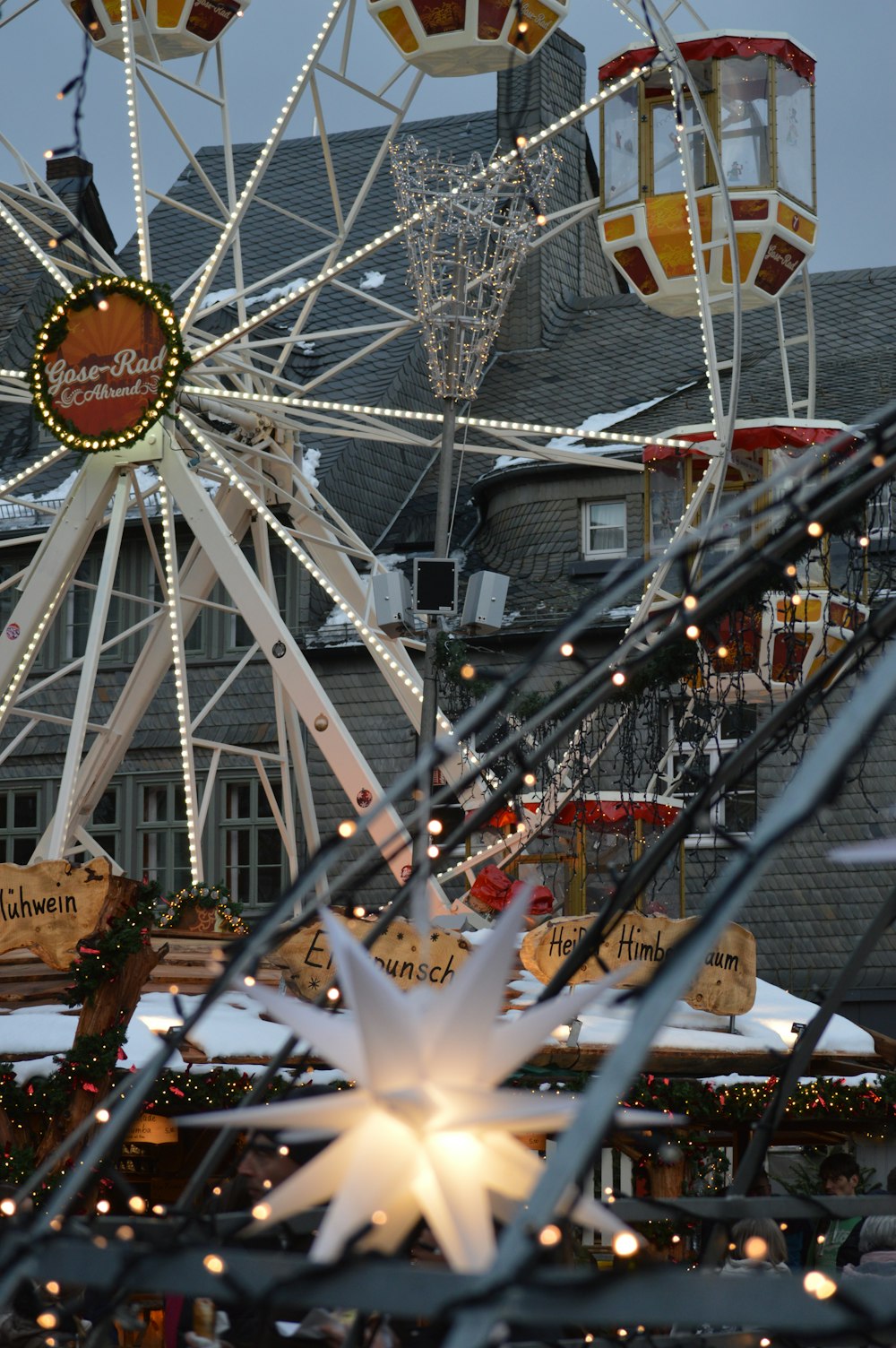 a ferris wheel with lights and decorations around it